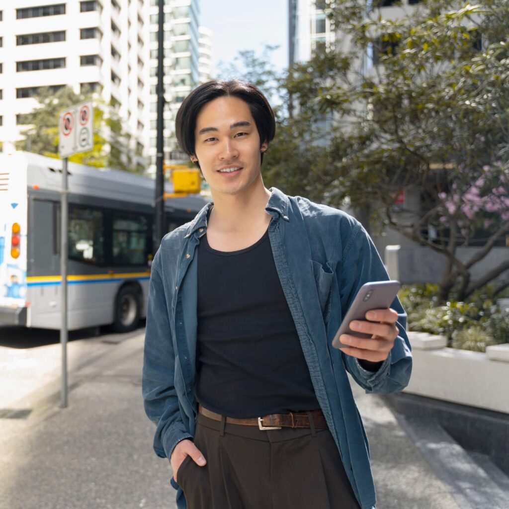 portrait of handsome asian man holding mobile phon 2025 02 20 09 45 34 utc 9T57G9R